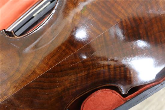 A silver mounted violin bow, an ivory mounted violin bow and a late 19th century German violin, cased